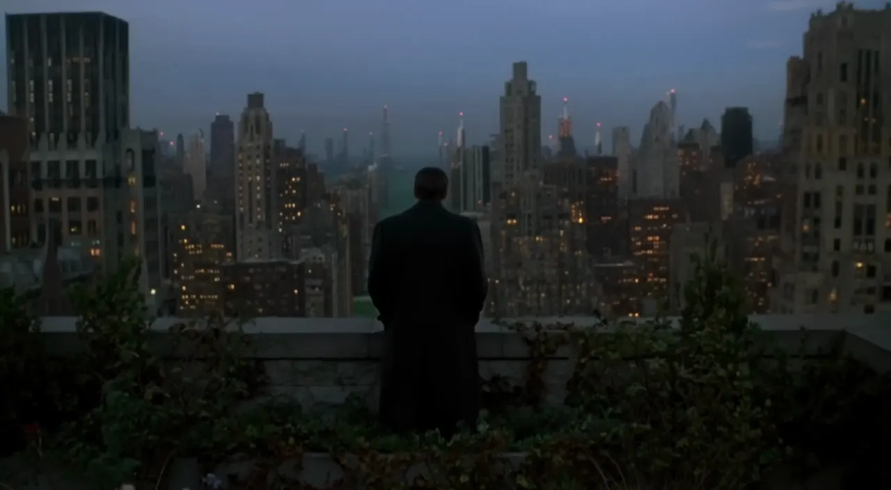 FLUX 3 image: a man on a rooftop terrace overlooking a city skyline at dusk